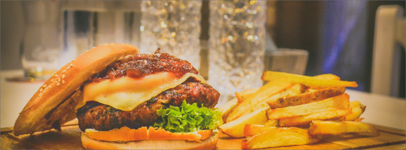 最上部のパンがずれ落ちたチーズバーガーとポテト